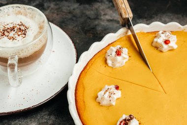 Homemade Thanksgiving Pumpkin Pie with whipped cream and latte. Clean eating, dieting, vegan food concept. top view.