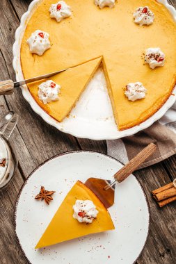 Festive pumpkin pie with whipped cream. vertical image. top view. place for text.