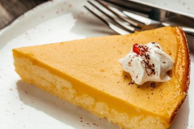 Festive pumpkin pie with whipped cream. Food recipe background. Close up.