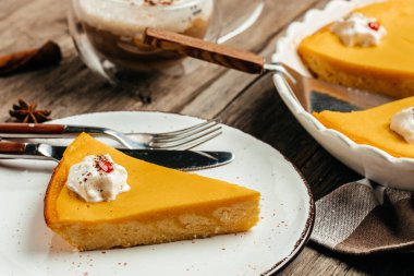 Fresh Pumpkin Pie with whipped cream on plate. Homemade pastry for Thanksgiving.