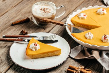 Homemade Thanksgiving Pumpkin Pie with whipped cream and latte. Clean eating, dieting, vegan food concept. top view.