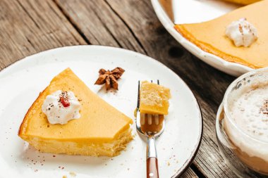 Fresh Pumpkin Pie with whipped cream on plate. Homemade pastry for Thanksgiving.