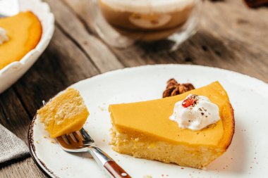 pumpkin cheesecake decorated with whipped cream for Thanksgiving Day. top view.