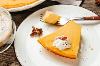 Krem şantili bir dilim balkabaklı cheesecake turtası, yemek tarifi geçmişi. Kapat..