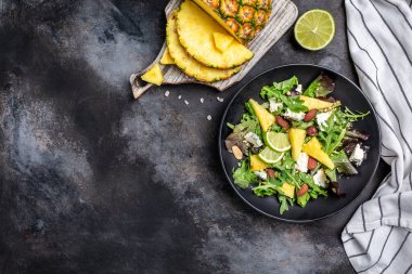 Akdeniz vejetaryen salatası, yanında ananas ve küflü peynir. Badem. Vejetaryen ya da sağlıklı yiyecekler. Üst görünüm.