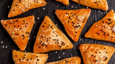 Geleneksel Hint mutfağı samosaları, lezzetli hamur işleriyle pişirilmiş hamur işleri, kırsal arka planda baharatlı popüler Hint atıştırmalıkları, üst manzara..