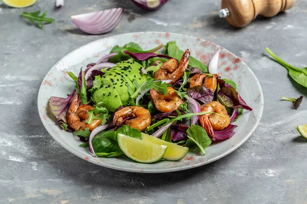 Green salad with avocado and shrimps salad. Seafood concept. Tasty veg mixed leaves, grilled prawn shrimps. Delicious breakfast or snack. Detox diet. Vegetarian lunch. Weight loss.