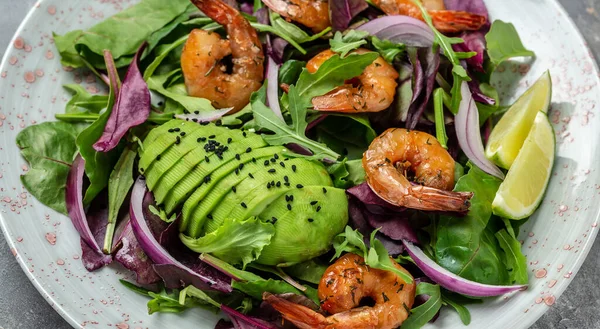 Shrimps salad, avocado, onion and smoked shrimps. Homemade vegetarian shrimp salad. Seafood concept. Tasty veg mixed leaves, grilled prawn shrimps.