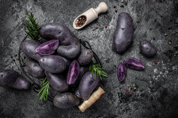 Organic purple sweet potato. Raw sweet potatoes or batatas. pomoea batatas. Batata potato. vegan food ingredient. banner, menu, recipe place for text, top view.