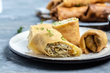 Tavuk eti ve peynirli krep ya da krep. Geleneksel Rus Shrovetide Maslenitsa festivali yemeği. Yemek tarifi geçmişi. Kapat.,