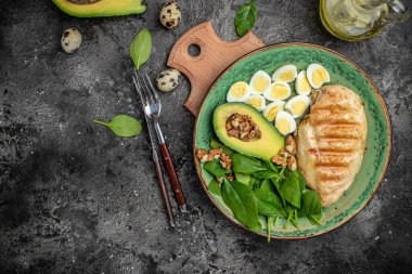 Salatalı tavuk fileto. Karanlık bir arka planda Buda Kupası. Sağlıklı yiyecekler, keto diyeti, sağlıklı yağlar, kilo vermek için temiz yiyecekler, afiş, menü, metnin tarifi, üst görünüm.