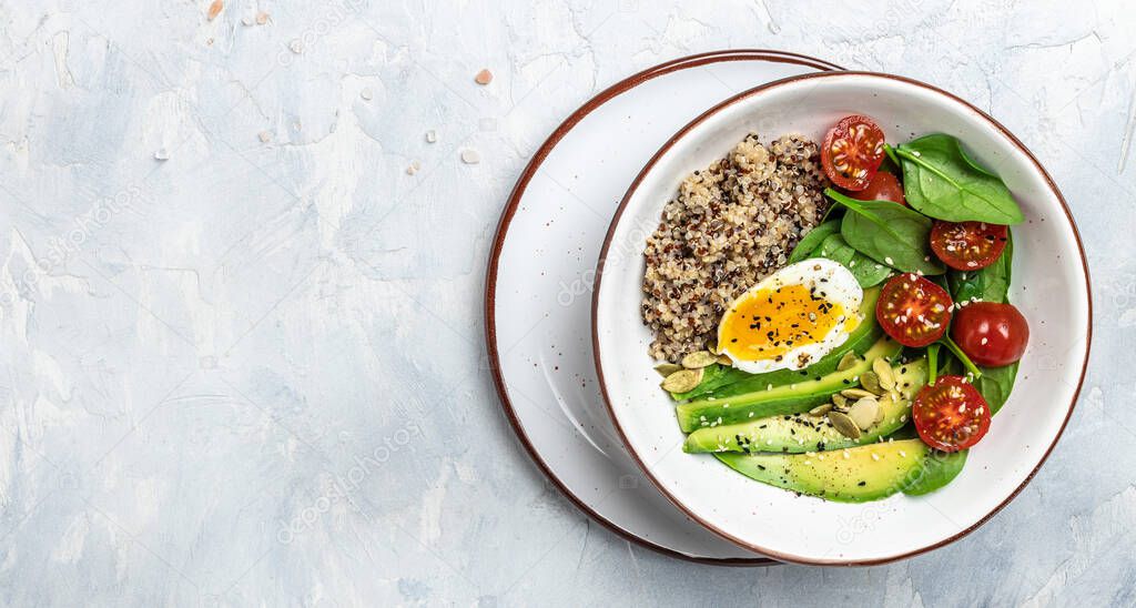 Keto diet plate quinoa, avocado, egg, tomatoes, spinach and sunflower seeds on light background. Healthy food, ketogenic diet, diet lunch concept, place for text, top view.