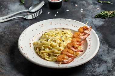 Izgara karides, beşamel sosu ve kekik ve fettucine makarna ile birlikte deniz ürünleri tagliatelle makarna kapatın. İtalyan yemeği. Sağlıklı diyet deniz ürünleri konsepti. Üst görünüm,