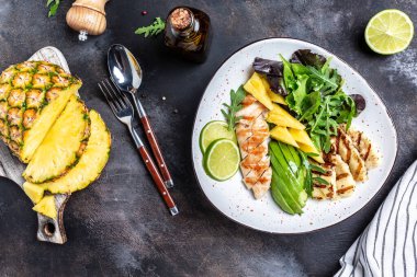 Izgara tavuk göğsü, ananas, yeşil roket salatası, limon ve zeytinyağı. Sağlıklı sulu yiyecekler. afiş, metin için menü tarifi yeri, üst görünüm.