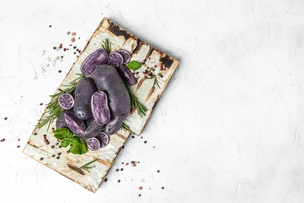 Raw cut purple sweet potatoes isolated on white background. Ipomoea batatas. Batata potato. Long banner format. top view.
