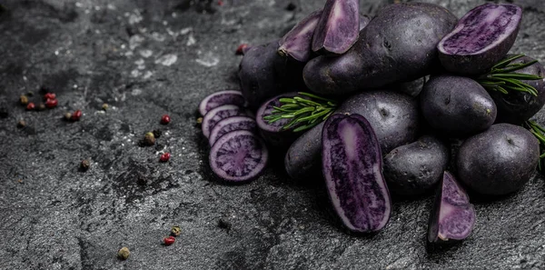 Organic purple sweet potato. Raw sweet potatoes or batatas. pomoea batatas. Batata potato, vegan food ingredient. banner, menu, recipe place for text, top view,