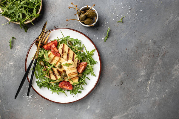 grilled slices of halloumi cheese with grill marks and mint. Cyprus squeaky cheese. Food recipe background. Close up.