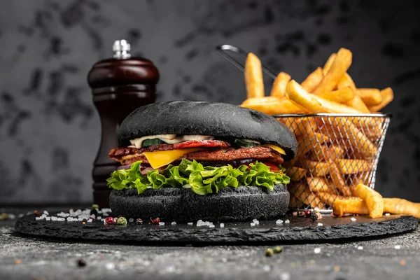 Homemade burger with grilled meat, vegetables, sauce on rustic wooden background. fast food and junk food concept.