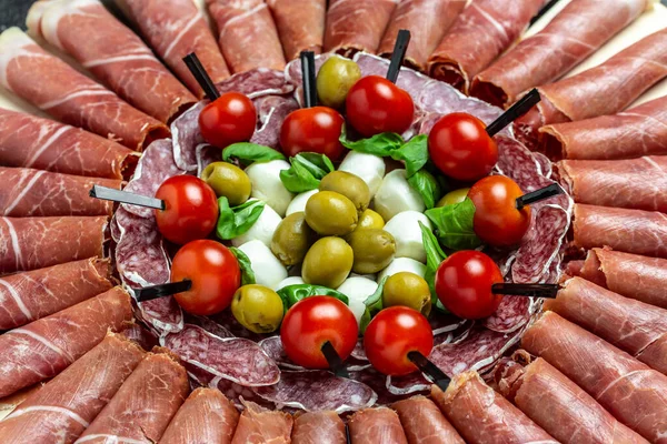 Antipasto platter jamon, prosciutto, ham, beef jerky, salami and cheese platter. Appetizer, catering food concept. place for text, top view.