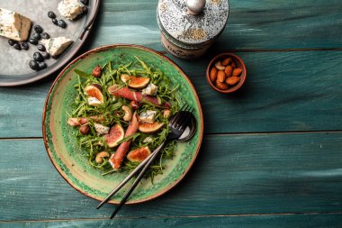 Lezzetli gurme peyniri, dilimlenmiş taze incir ve üzümlerle servis edilen yumuşak peynirlerin kırsal ahşap arka planda servis edilmesi, yemek servisi, afiş, menü, tarif, metin için yer.