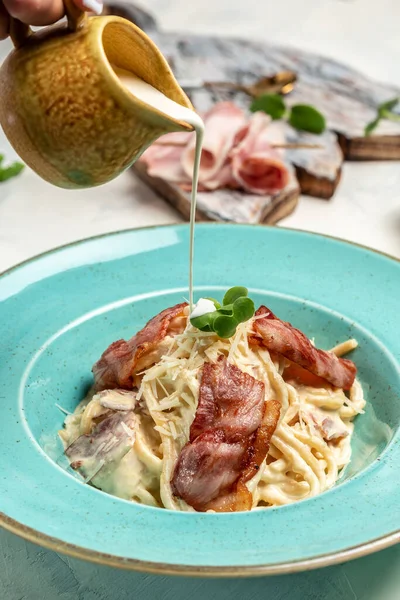 Carbonara pasta, spaghetti with pasta bacon, parmesan cheese and cream sauce. Italian pasta. cooking concept, vertical image. copy space.