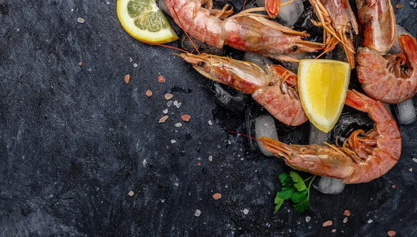 Close up Shrimps, prawns. Seafood Red Argentine shrimps with salt, Wild shrimps, ocean jumbo shrimps. Long banner format. top view.