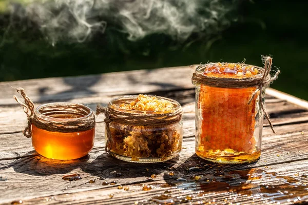 Natural honey comb and a glass jar on wooden table. Honey background. Sweet honey. Long banner format. space for text.