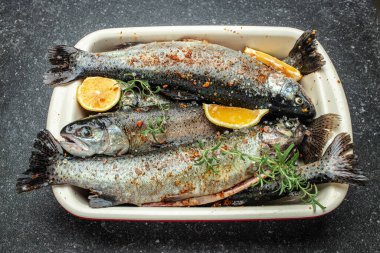 marinated trout fish with salt, lemon and spices, Healthy food or diet nutrition concept. banner, menu, recipe place for text, top view.