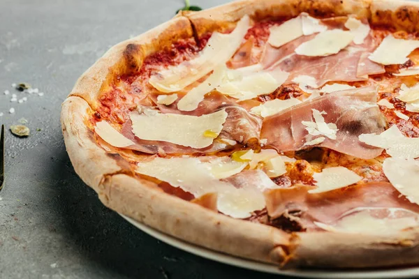 pizza with prosciutto. Pizza with Ham and parmesan cheese, Italian cuisine top view. place for text.