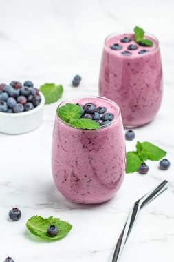 Bilberry yogurt cocktail on a light background. Natural detox. vertical image. top view. place for text.