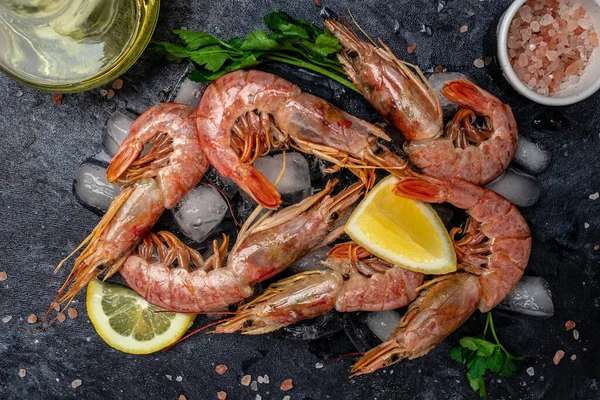 Seafood. Red Argentine shrimps with salt and lemon, Wild shrimps, ocean jumbo shrimps on a dark background. banner, menu, recipe place for text, top view.