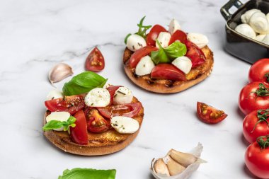Mozzarella, kiraz domatesli ve taze fesleğenli Caprese tostları. Geleneksel İtalyan aperatifi veya aperatifi, antipasto. afiş, menü, metin için tarif yeri, üst görünüm.
