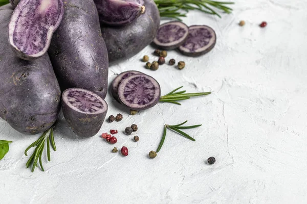Raw cut purple sweet potatoes isolated on white background. Ipomoea batatas. Batata potato. Long banner format. top view.