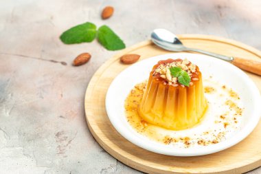 Karamelli panna cota. Hafif arkaplanda kremalı karamel tatlısı. afiş, menü, metin için tarif yeri, üst görünüm.