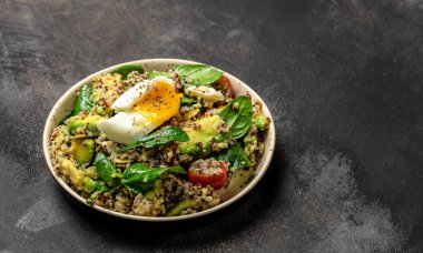 İçinde avokado, yumurta, domates, ıspanak ve ay çekirdeği olan kinoa budha kasesi. Ev yapımı yemek. Sağlıklı, temiz yemek. Vegan ya da glütensiz diyet, metin yeri, üst görünüm,