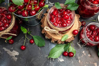 Berries cherry with syrup. Berries cherry with syrup. Canned fruit on a dark background. Long banner format.