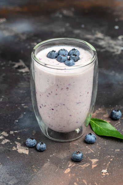 Blueberry jogurt smoothie in glass jar, Healthy breakfast of blueberry yoghurt shake with fresh fruit, vertical image. top view. place for text,