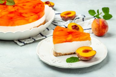 dessert peaches, cheesecake with peache jelly on white plate. Restaurant menu, dieting, cookbook recipe top view.