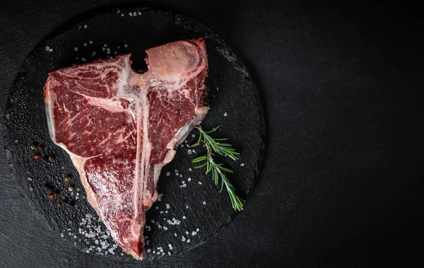 The T-bone or porterhouse steak of beef cut from the short loin. steak include T-shaped bone with meat on each side. Porterhouse steaks are cut from the rear end of the short loin.