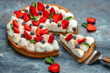 piece of tasty cake pie tart with fresh strawberries, raspberries, blueberry with shovel. Restaurant menu, dieting, cookbook recipe top view.