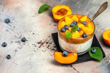 Peach smoothie dessert mousse yogurt with peaches blueberry chia. Eating healthy, vitamin rich Breakfast.