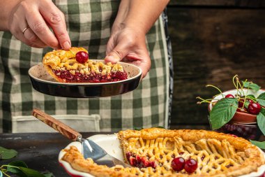 Woman with tasty cherry pie. One piece on a plate and the whole homemade cherry pie.