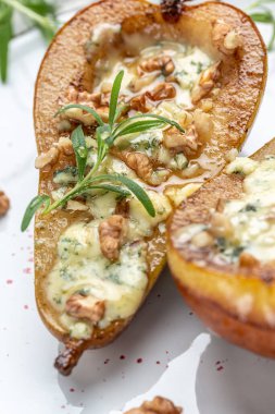 Pears baked with blue cheese, nuts and honey. French cuisine. Keto diet. Vegetarian lunch. banner, menu, recipe , top view.
