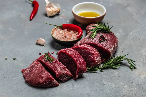 Beef Tenderloin fillet with rosemary and spices. Preparing fresh beef steak ready to cook, Restaurant menu, dieting, cookbook recipe. place for text. top view.