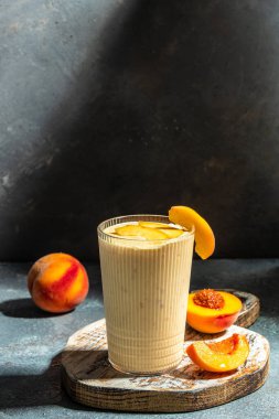 protein shake with peach milkshake, Summer breakfast drink, fresh blended peach smoothie, vertical image place for text,