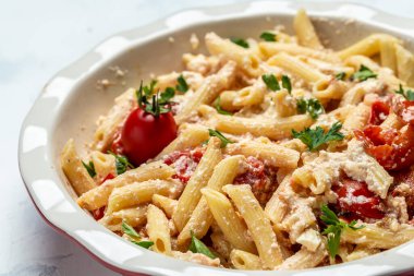 Çeri domatesli Fetapasta tarifi, beyaz tabakta beyaz peynir, sarımsak ve kekik. en üstteki görünüm.