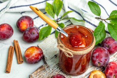 Sweet homemade plum jam on a light background. place for text, top view.