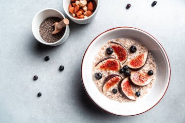 oatmeal with fig pieces and chia seeds, Healthy breakfast Gluten, lactose free, Fitness food, top view,