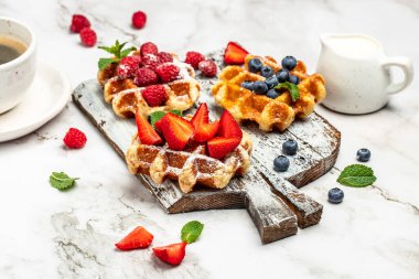 belgian waffles. Berry Belgian Waffle with raspberries, strawberries and blueberries. Delicious breakfast or snack.