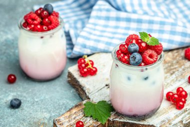 Healthy layered dessert with yogurt, jam, red currant and blueberries. Natural detox. banner, menu, recipe place for text, top view.